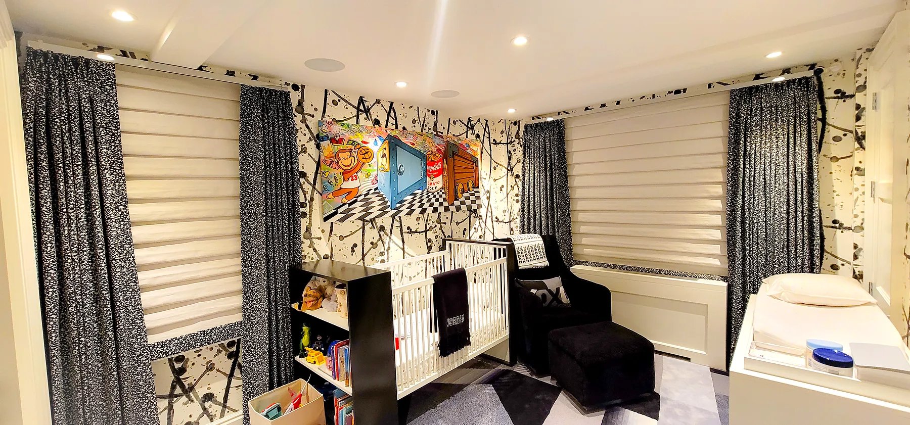 Patterned drapery side panels layered over roman shades in a whimsical nursery