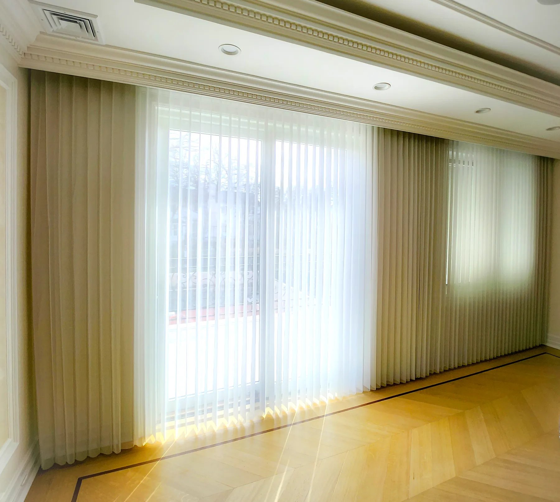 Layered ripplefold drapery with sheer panels behind fuller side drapes